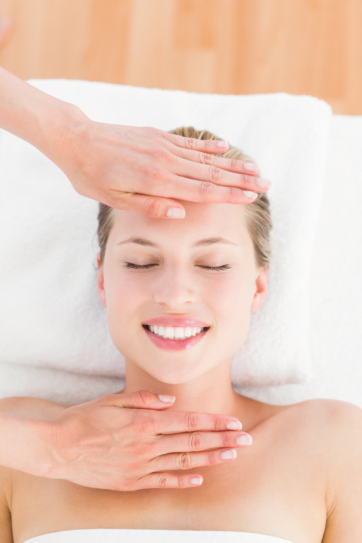 Calm woman receiving reiki treatment