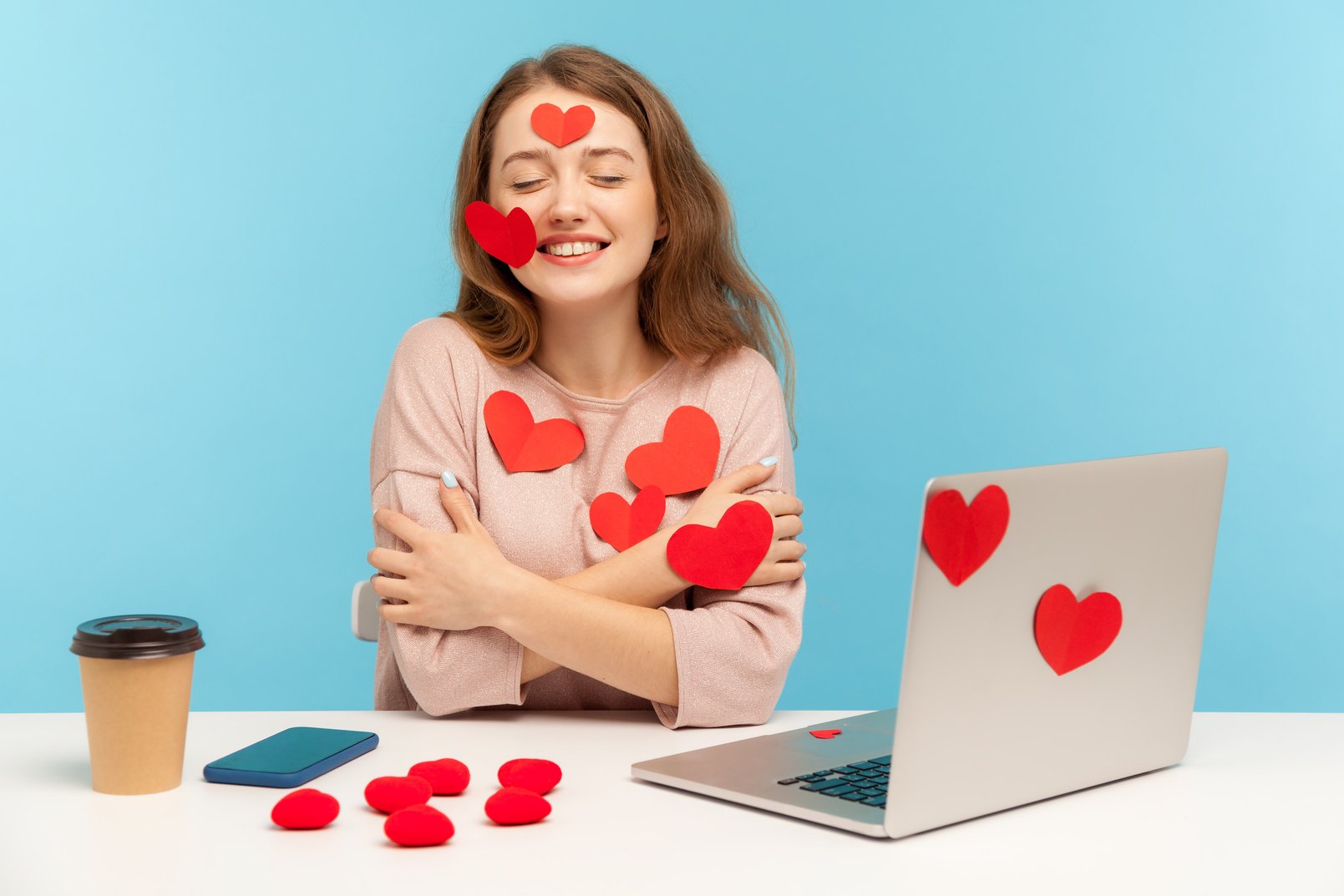 Emotional Young Woman Working on Laptop on Blue Background.